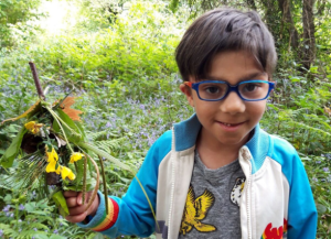 Robi in woods holding some leaves